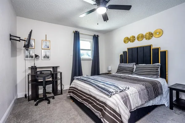 a bedroom with a bed and a chandelier