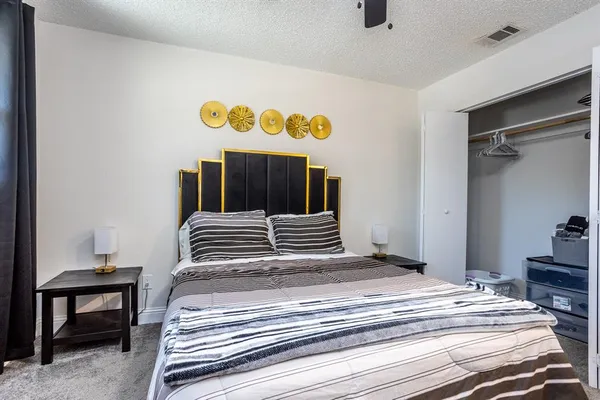 a bedroom with a bed and a table in it