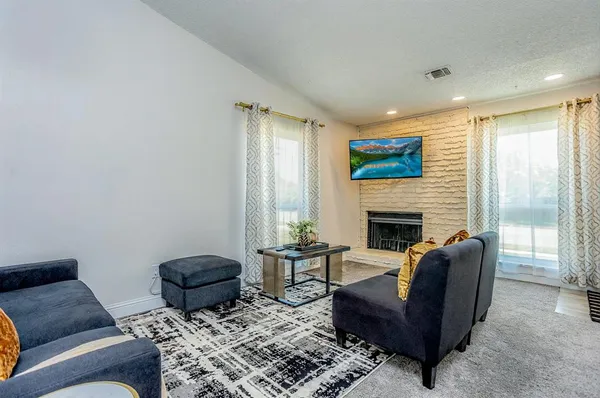 a living room with furniture and a fireplace