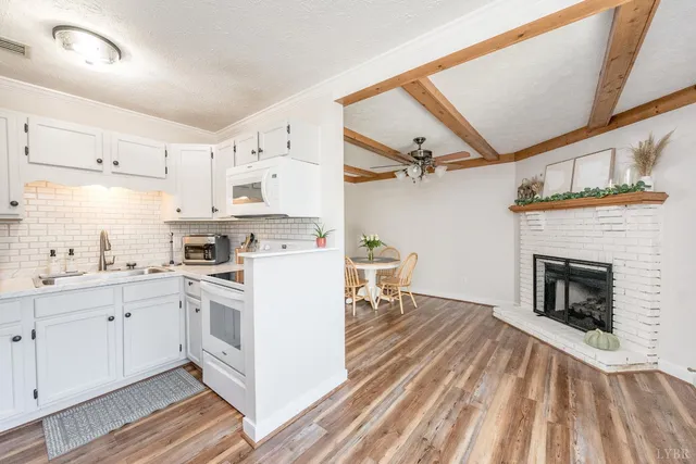a kitchen with a sink cabinets and a fireplace
