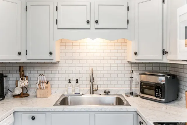 a kitchen with sink and cabinets