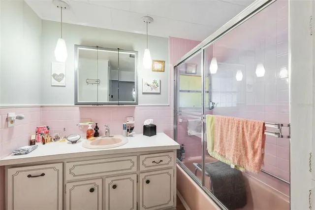 a kitchen with a sink a refrigerator and cabinets