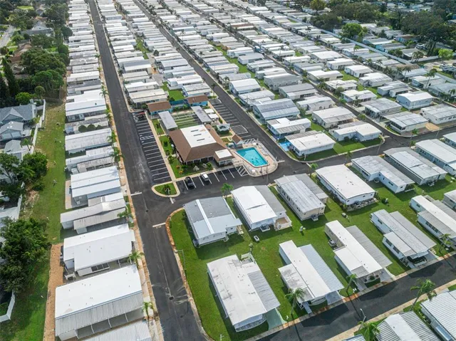 an aerial view of a house with a yard basket ball court and outdoor seating