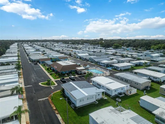 an aerial view of houses with a yard