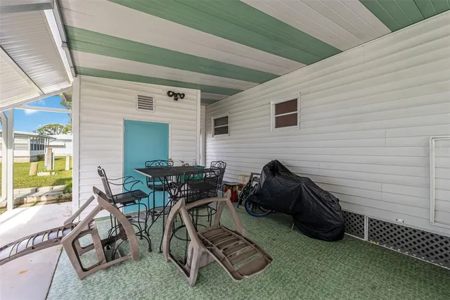 a view of a patio with chairs and a table