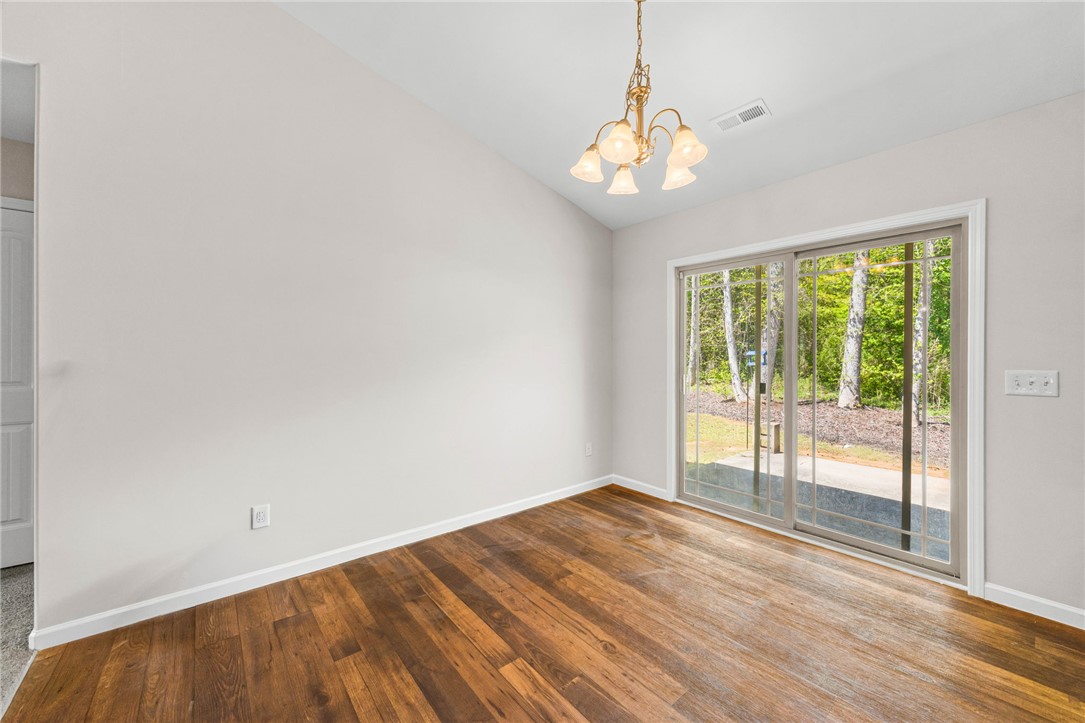113 Crofton Court Easley, SC 29642 - Photo 9 of 33 This bright space features rich hardwood flooring and convenient sliding glass doors leading to the outdoors.