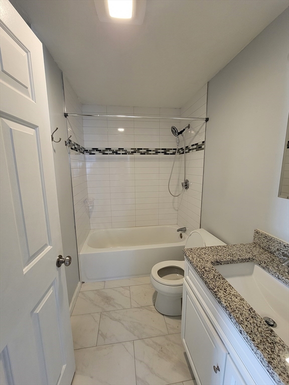 7 Gibbs Street, Unit 7 Worcester, MA 01607 - Photo 10 of 20 a bathroom with a granite countertop sink toilet and shower