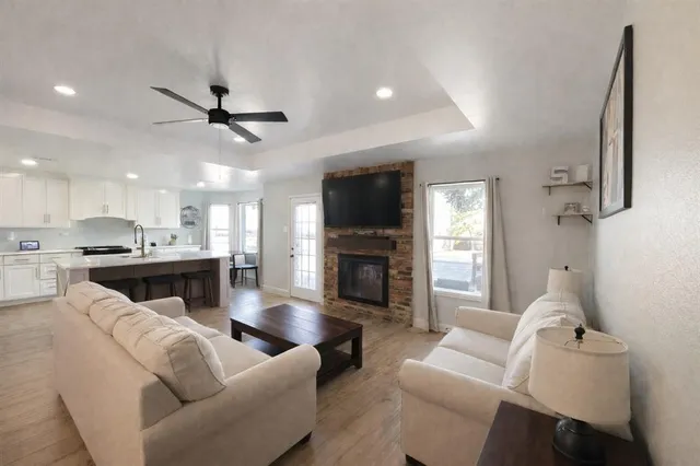 a living room with furniture a fireplace and a flat screen tv