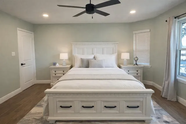 a bedroom with a bed and window