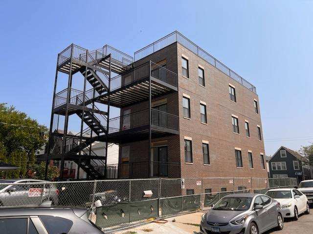 1624 South Carpenter Street, Unit 1 Chicago, IL 60608 - Photo 6 of 6 a front view of a building with parking space