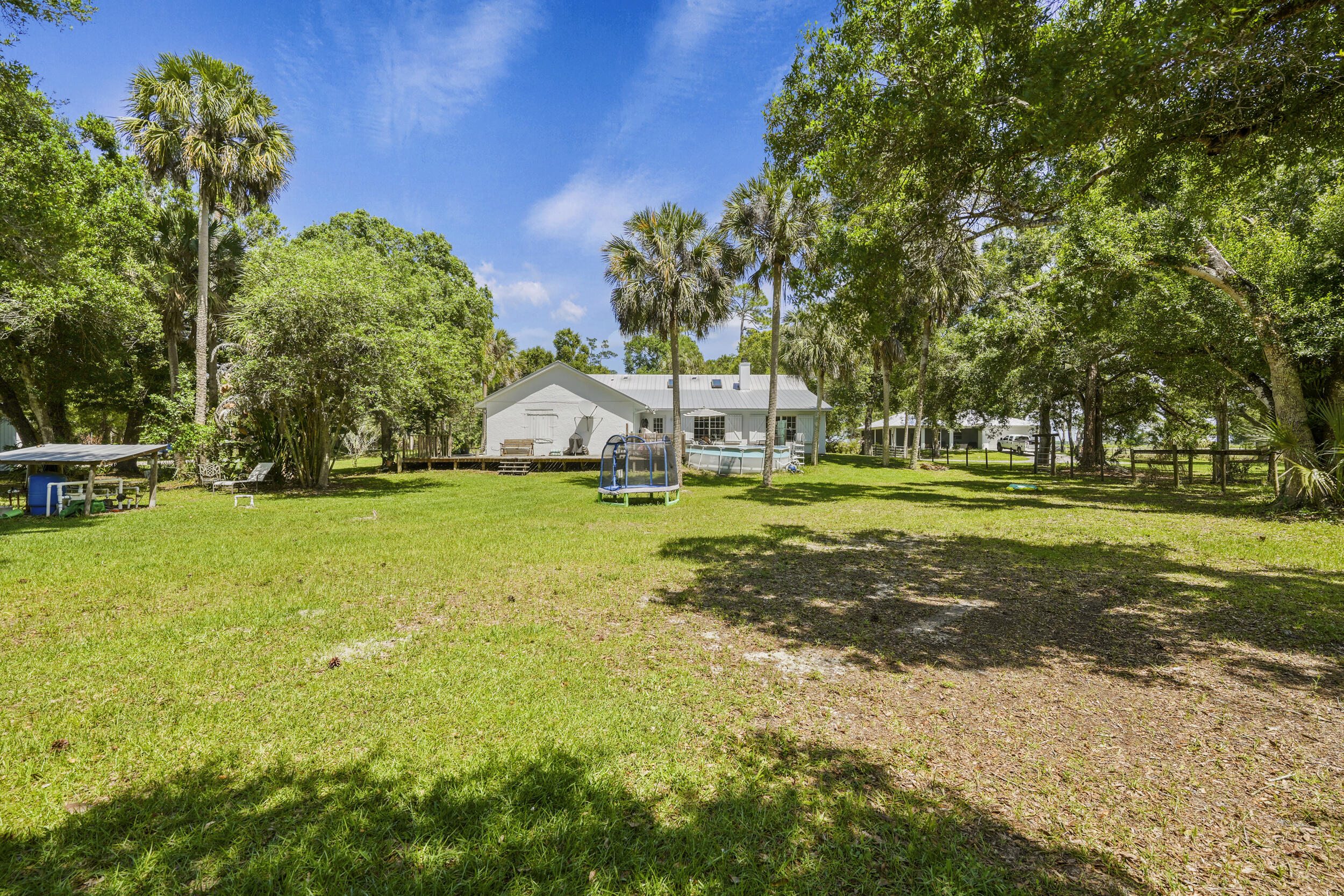 6289 South Header Canal Road Port St. Lucie, FL 34987 - Photo 26 of 52 a view of yard with swimming pool and green space