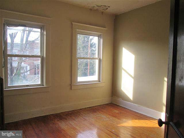353 Marydell Road Baltimore, MD 21229 - Photo 14 of 20 a view of an empty room with wooden floor and a window