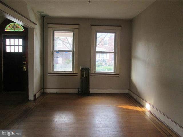 353 Marydell Road Baltimore, MD 21229 - Photo 5 of 20 an empty room with wooden floor and windows