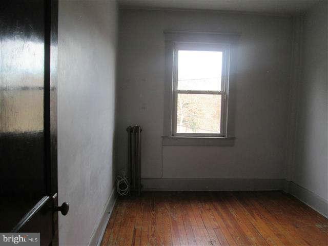 353 Marydell Road Baltimore, MD 21229 - Photo 9 of 20 an empty room with wooden floor and windows