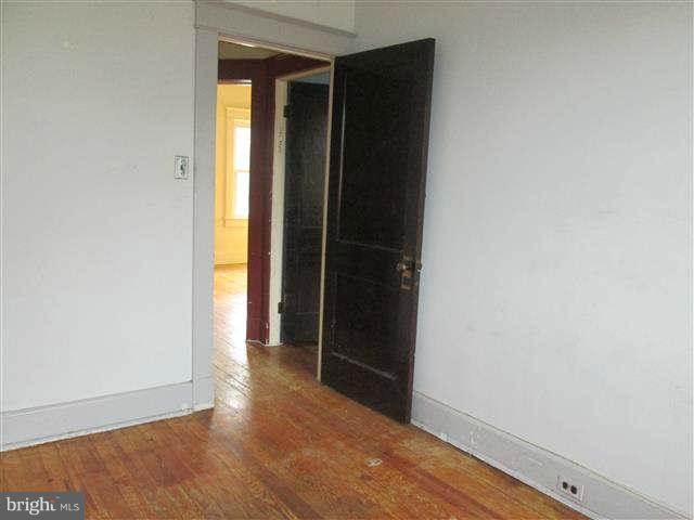 353 Marydell Road Baltimore, MD 21229 - Photo 10 of 20 an empty room with wooden floor and closet