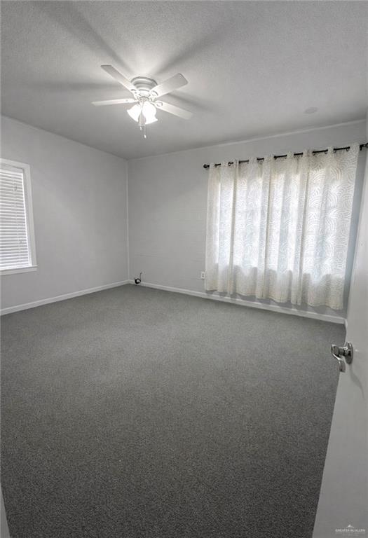1403 North Shary Road Mission, TX 78572 - Photo 7 of 9 Spare room with carpet flooring, ceiling fan, and a textured ceiling