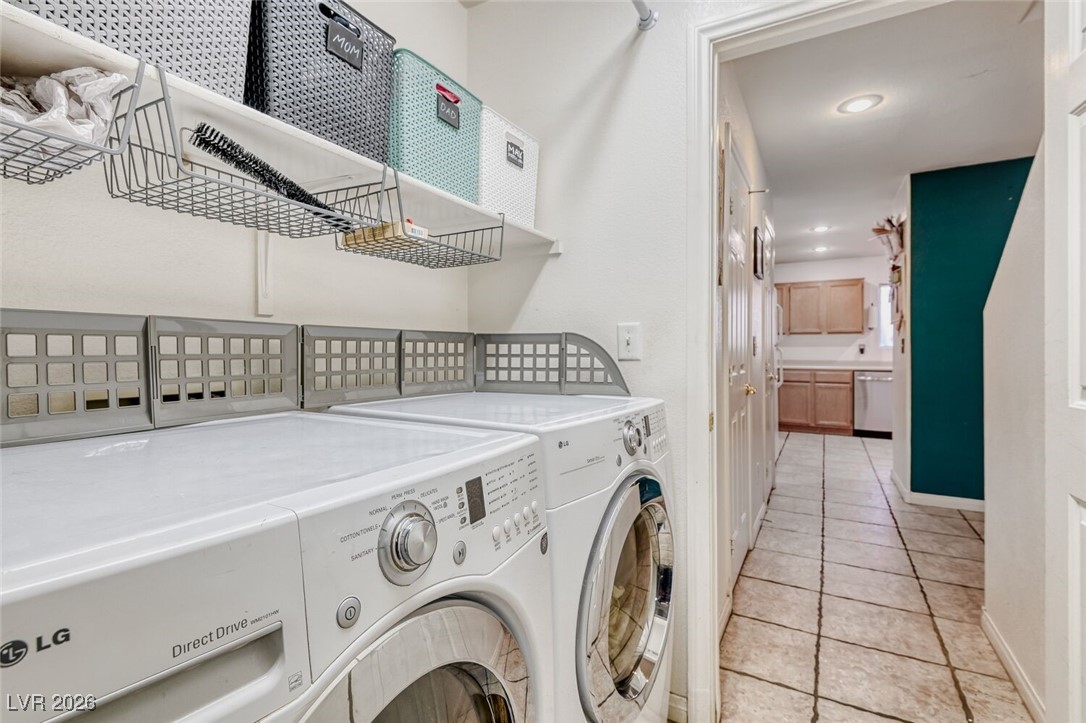 2046 Peacemaker Road Las Vegas, NV 89183 - Photo 8 of 17 Laundry Room with shelving, garage access, washer and dryer included.