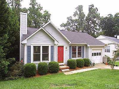 a view of a house with a yard and plants