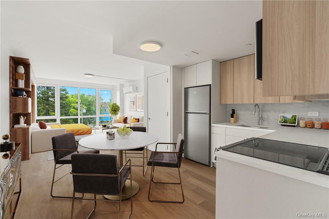 10 Lyon Place, Unit 3J White Plains, NY 10601 - Photo 2 of 17 a living room with stainless steel appliances furniture a large window and a refrigerator