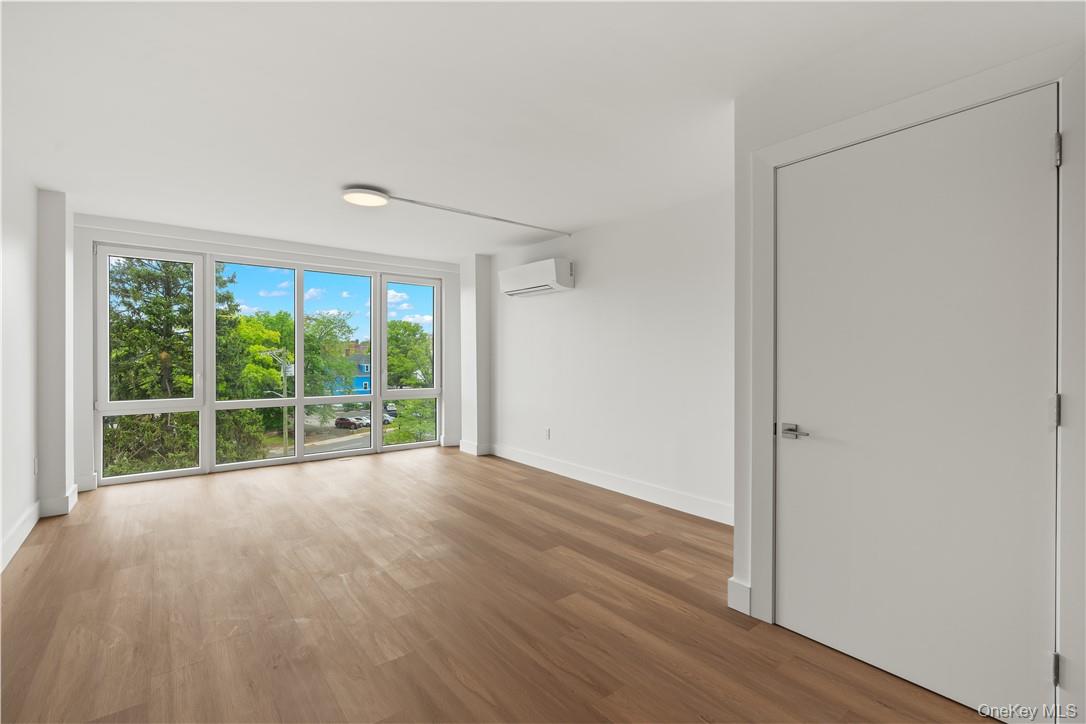 10 Lyon Place, Unit 3J White Plains, NY 10601 - Photo 4 of 17 a view of an empty room with wooden floor and a window