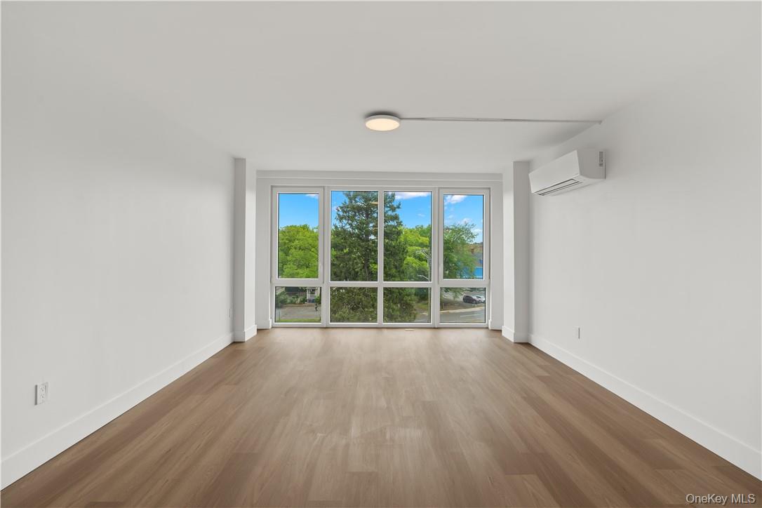 10 Lyon Place, Unit 3J White Plains, NY 10601 - Photo 5 of 17 wooden floor in an empty room with a window