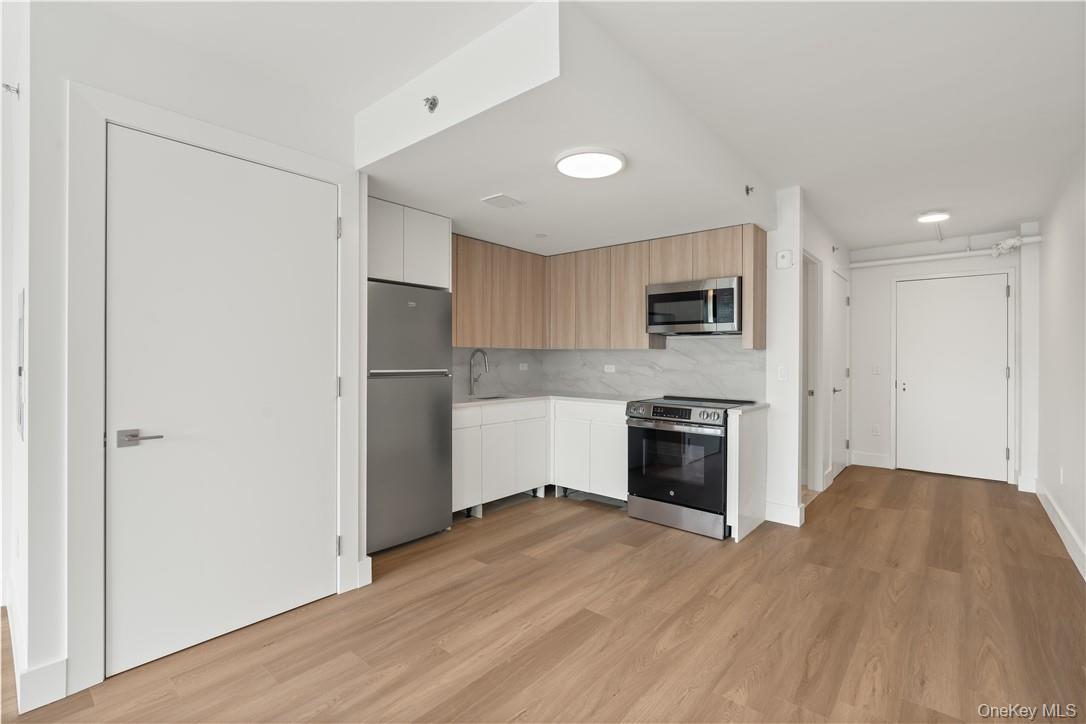10 Lyon Place, Unit 3J White Plains, NY 10601 - Photo 8 of 17 a kitchen with a refrigerator and a stove top oven