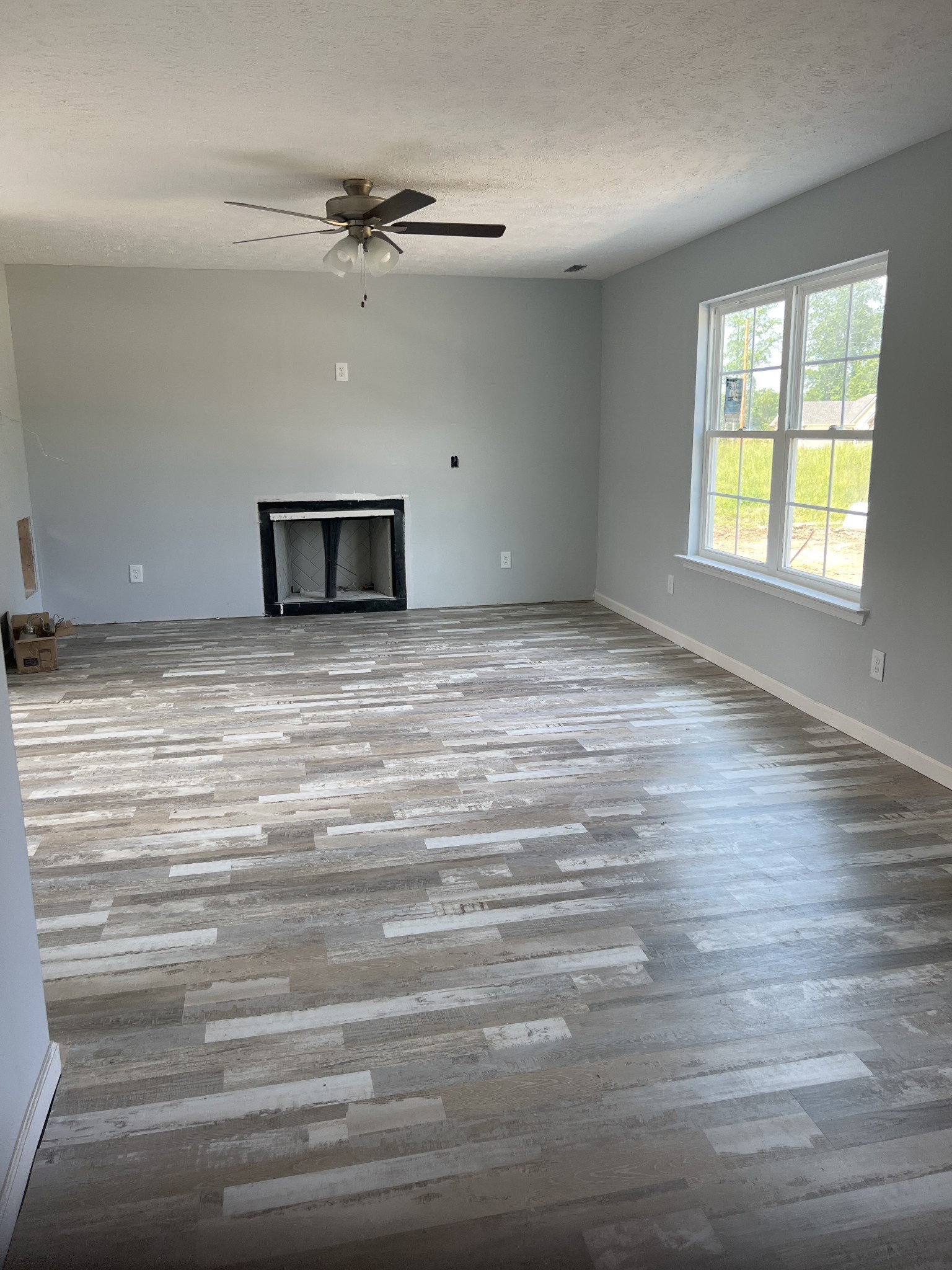 258 Timber Circle Manchester, TN 37355 - Photo 5 of 11 a view of an empty room with a window and wooden floor