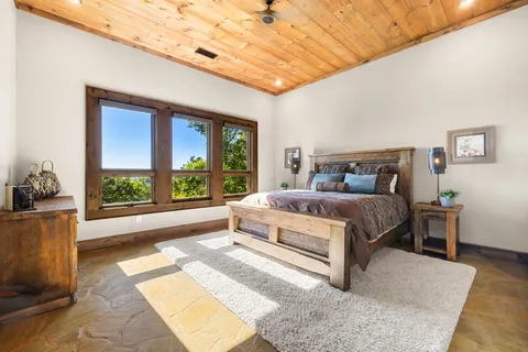 a bedroom with a large bed and a window