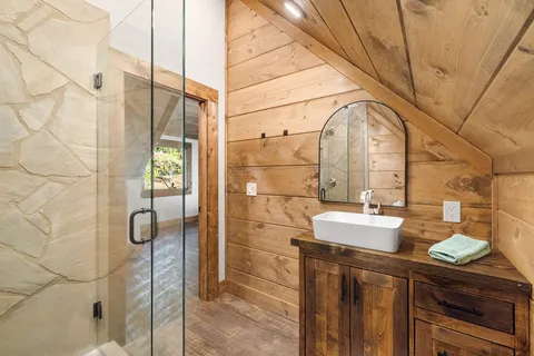 a bathroom with a sink mirror and shower