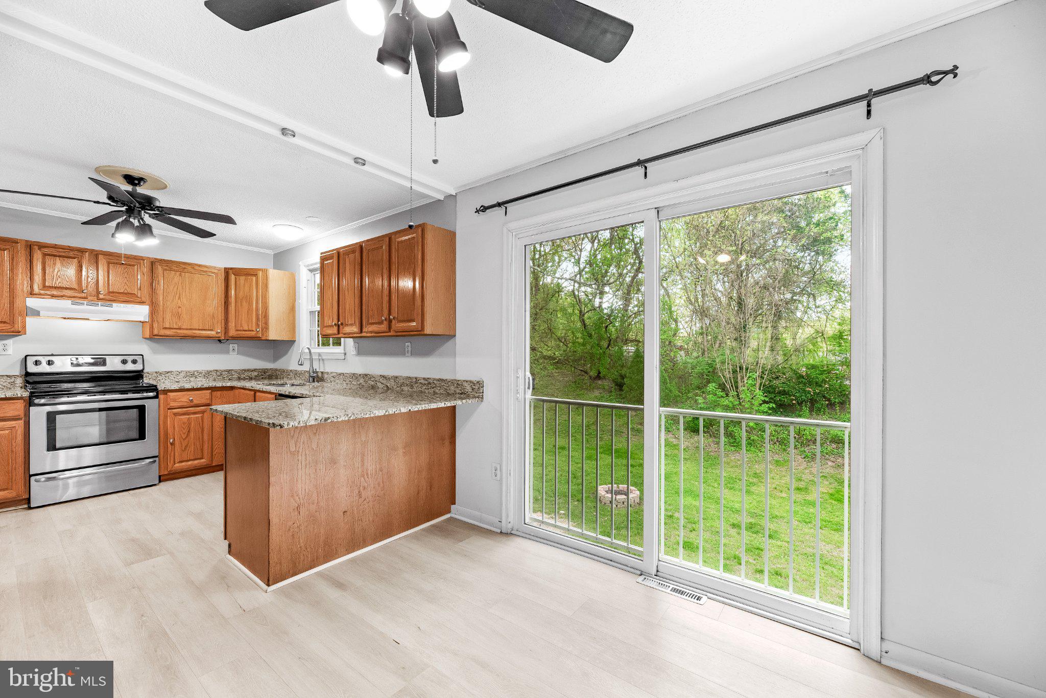 11951 Prince Court Dunkirk, MD 20754 - Photo 17 of 72 a open kitchen with stainless steel appliances granite countertop a stove a sink and a refrigerator