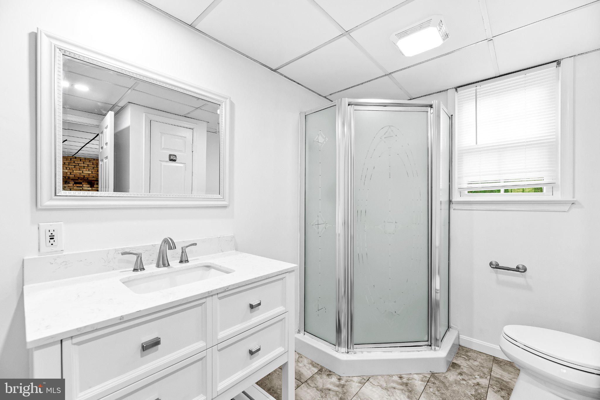 11951 Prince Court Dunkirk, MD 20754 - Photo 30 of 72 a bathroom with a sink a mirror a toilet and shower
