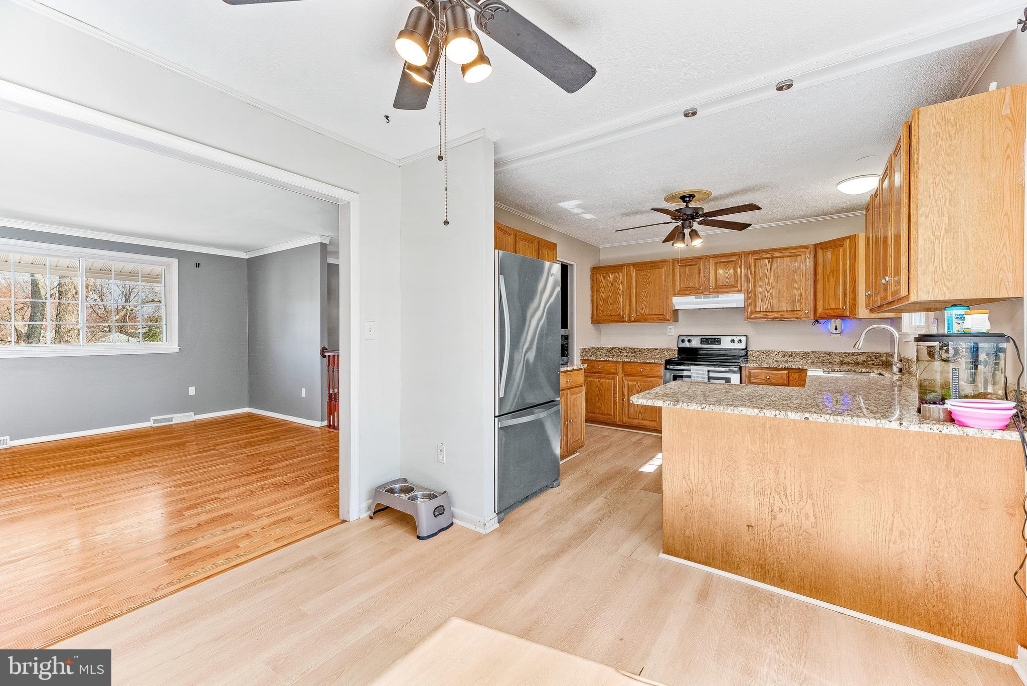 11951 Prince Court Dunkirk, MD 20754 - Photo 52 of 72 a view of a kitchen with kitchen island a counter top space a sink and appliances
