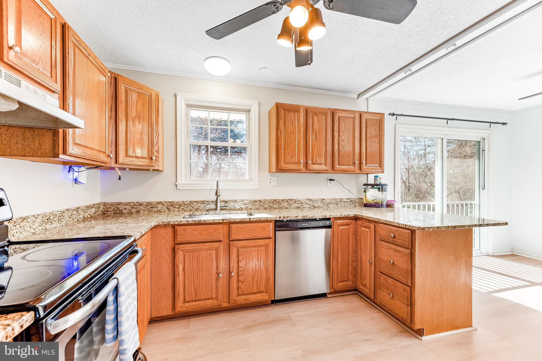 11951 Prince Court Dunkirk, MD 20754 - Photo 54 of 72 a kitchen with stainless steel appliances granite countertop a sink and cabinets