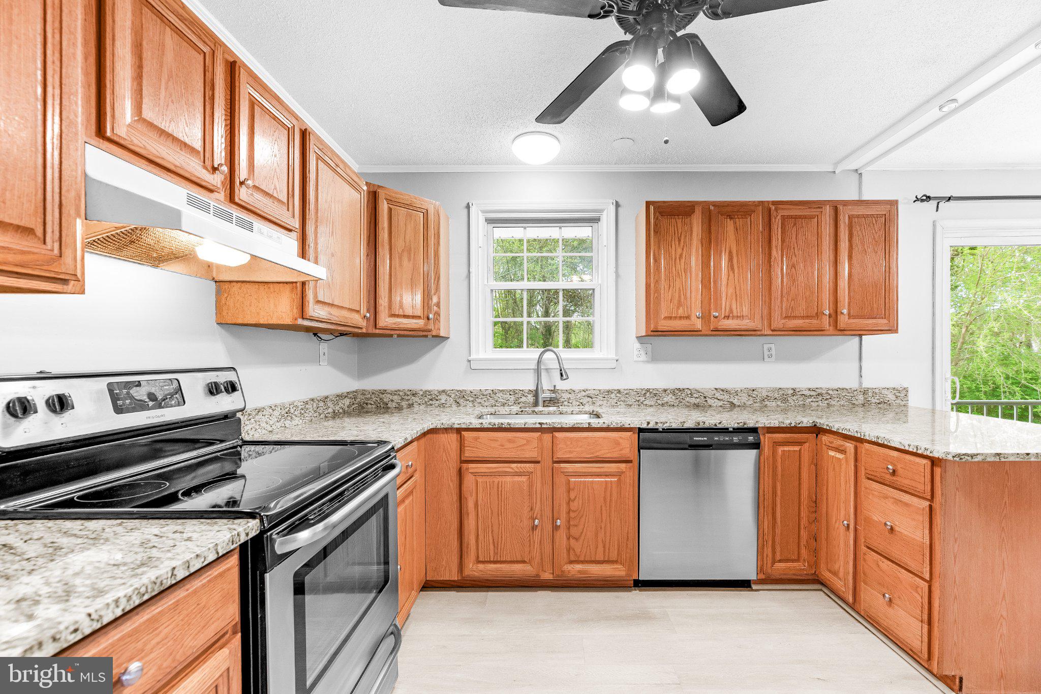 11951 Prince Court Dunkirk, MD 20754 - Photo 10 of 72 a kitchen with stainless steel appliances granite countertop a sink a stove cabinets and a window