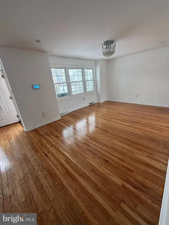 a view of a room with wooden floor and stairs