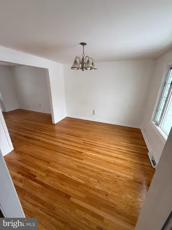 a view of a room with wooden floor and stairs