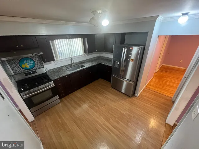a metallic refrigerator freezer sitting in a kitchen
