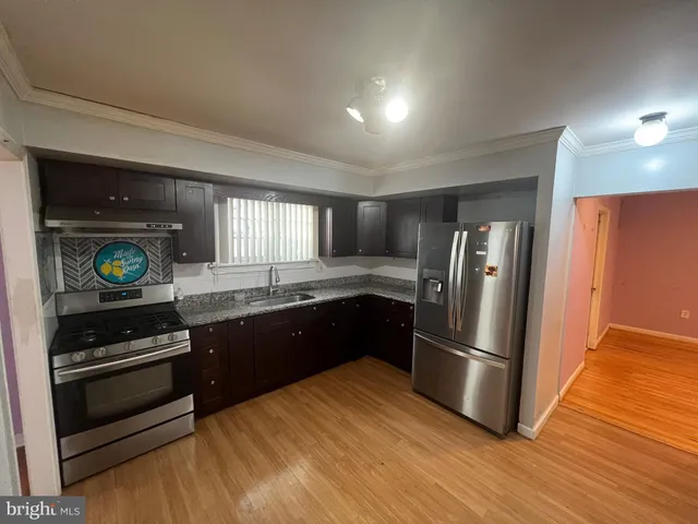 a view of an empty room with a fireplace and a window