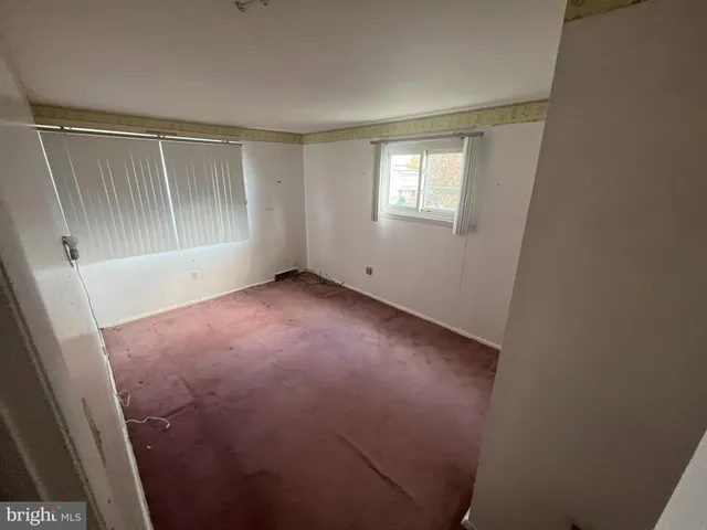 wooden floor in an empty room with a mirror