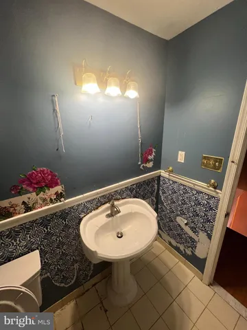 a bathroom with a sink toilet and mirror