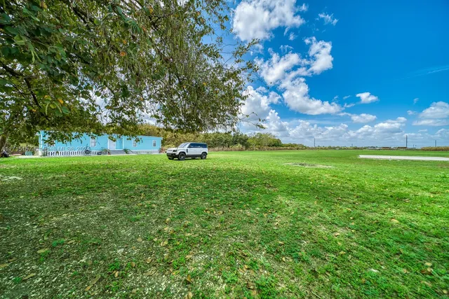 a backyard of a house with lots of green space