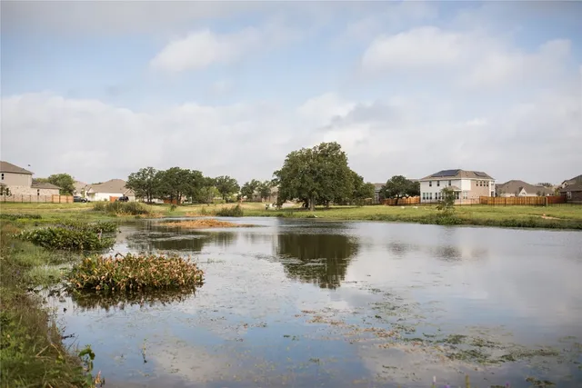 a view of a lake with houses in the back
