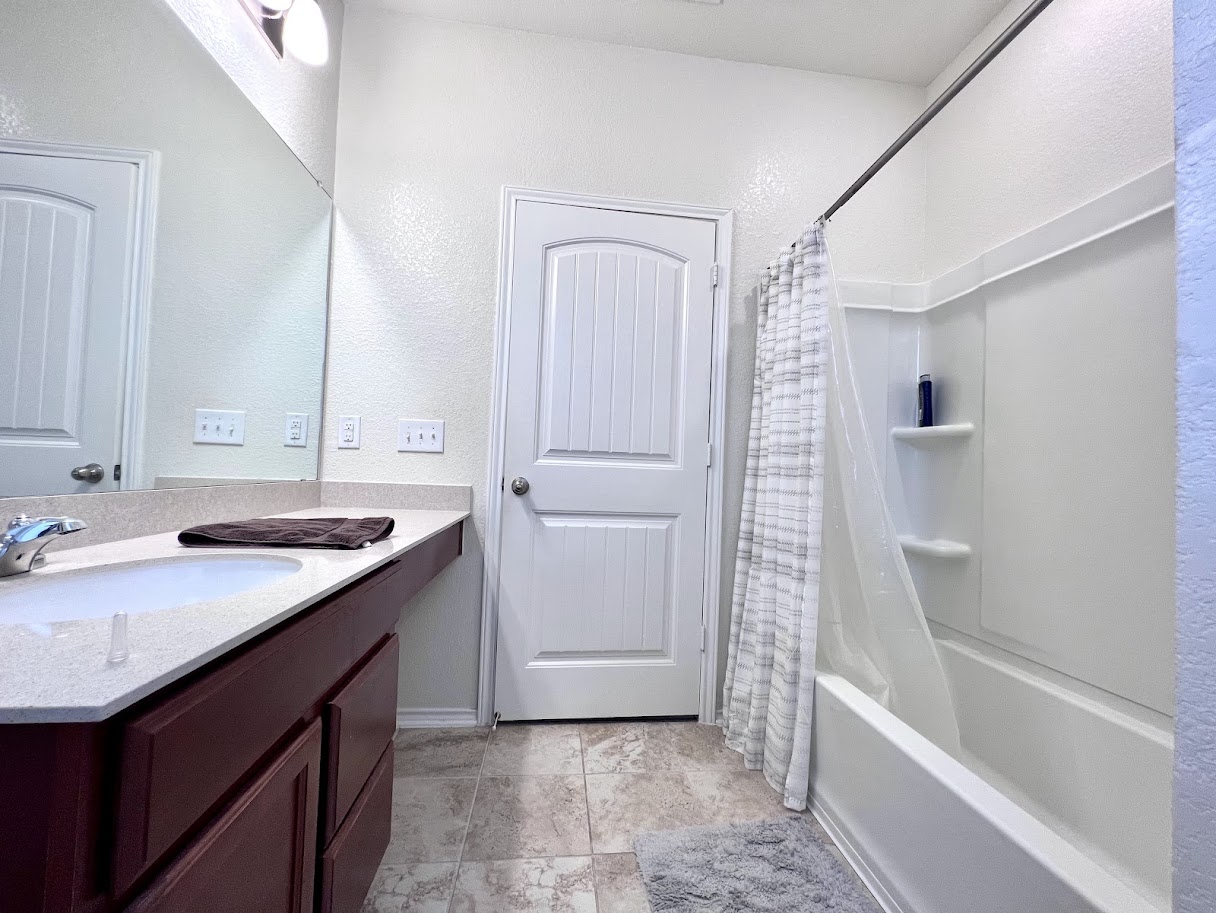 7900 Crystalbrook West Austin, TX 78724 - Photo 9 of 27 a bathroom with a tub sink vanity granite and mirror