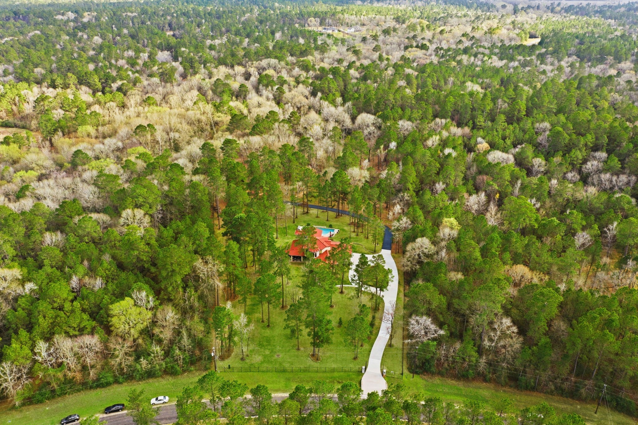 280 Sundog Road Huntsville, TX 77340 - Photo 50 of 50 Sweeping aerial view of the property highlights the open grounds and surrounding woods, offering privacy, natural beauty, and a truly special place to call home.