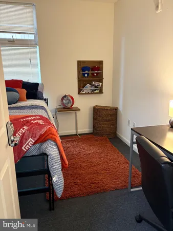 a bedroom with a bed and two windows