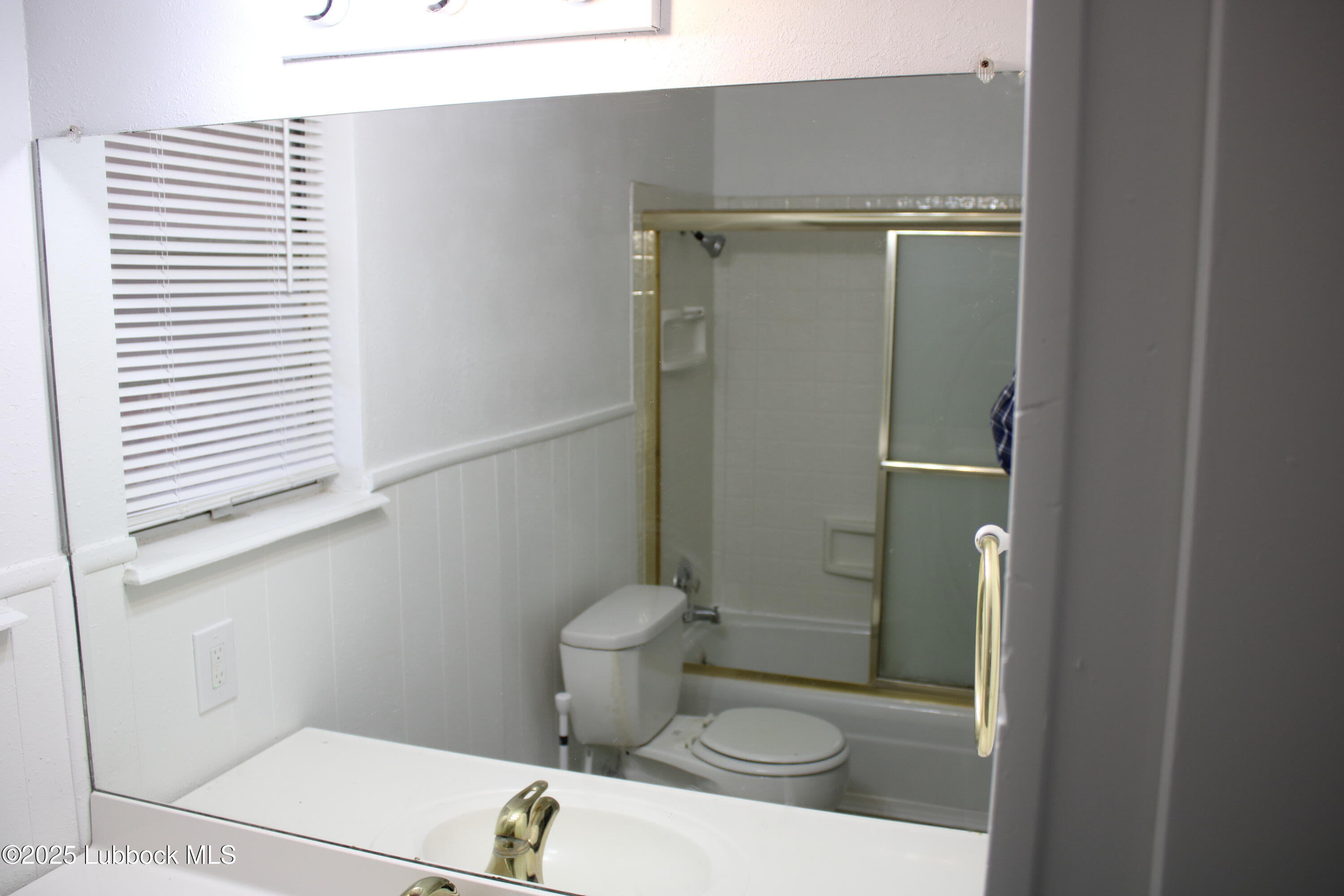 5503 36th Street Lubbock, TX 79407 - Photo 17 of 22 a bathroom with a granite countertop toilet and a shower