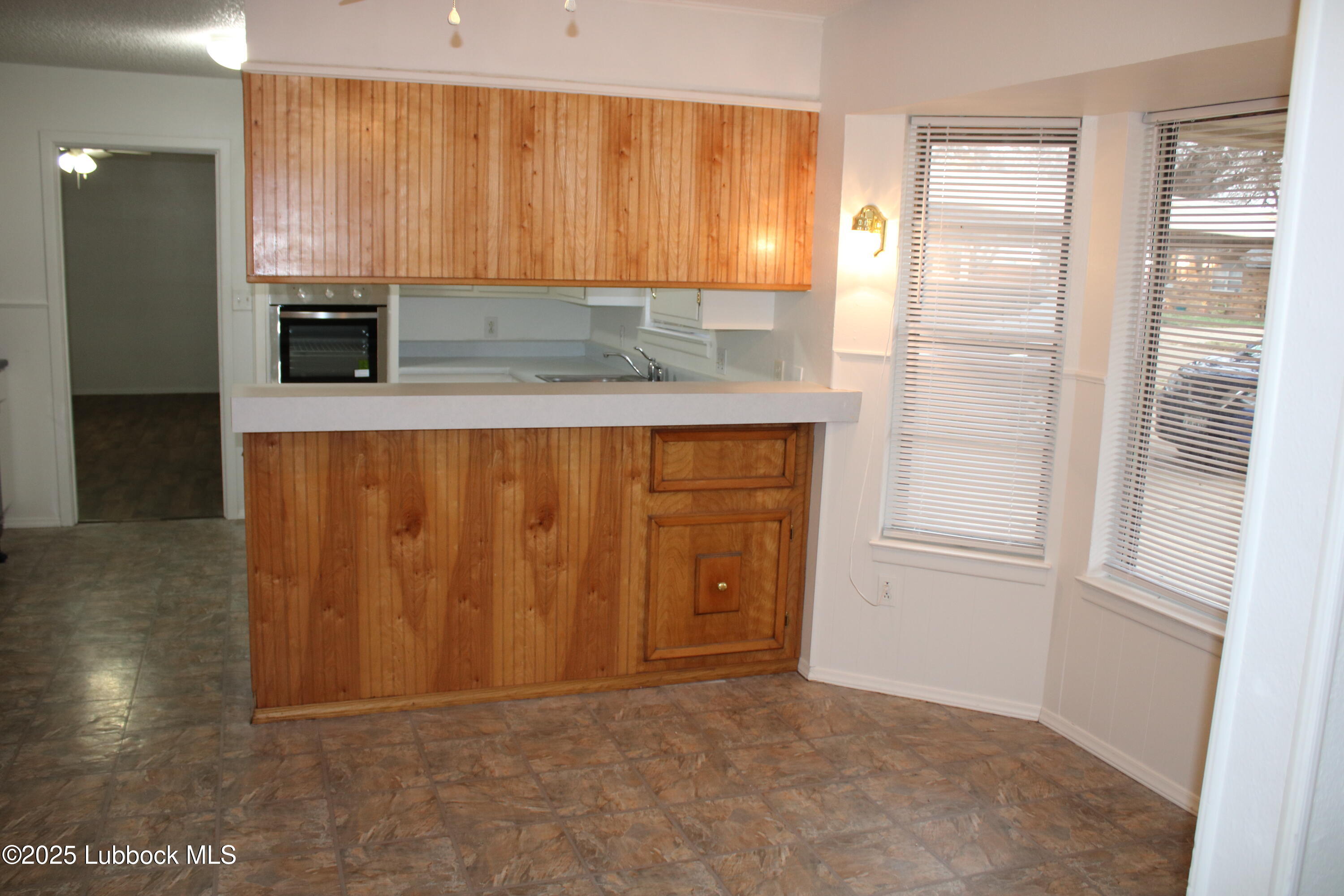 5503 36th Street Lubbock, TX 79407 - Photo 3 of 22 a view of kitchen with wooden floor and cabinets
