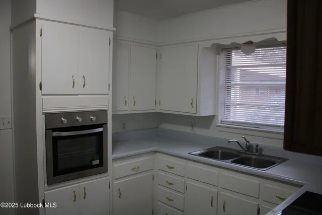 a kitchen with a sink stove and cabinets