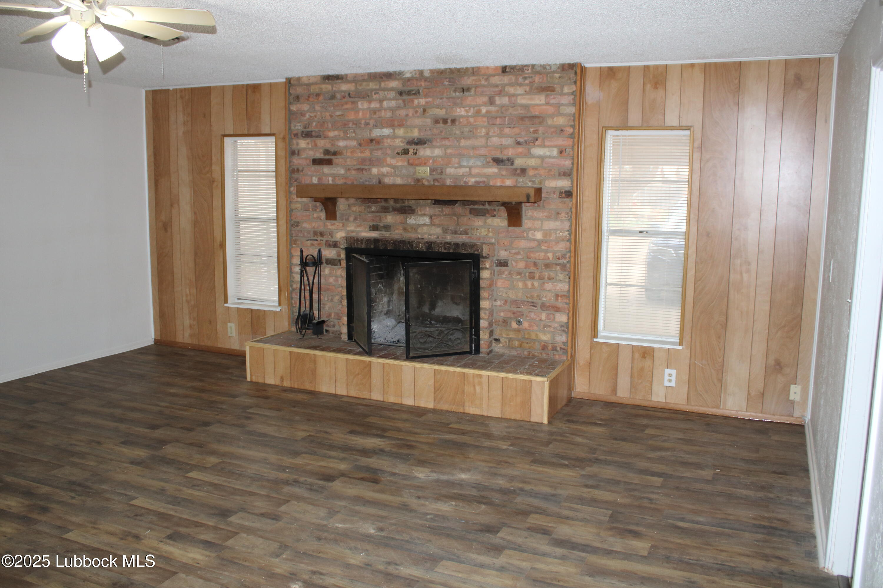 5503 36th Street Lubbock, TX 79407 - Photo 8 of 22 a view of an empty room with wooden floor and a window