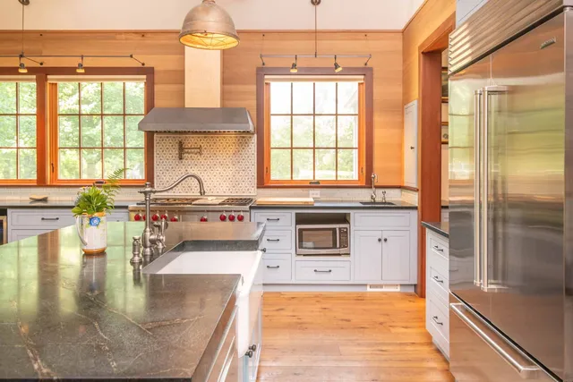 a kitchen with stainless steel appliances granite countertop a sink and a stove